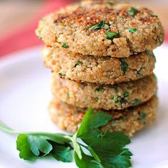 some food is on a white plate with green garnishes and parsley