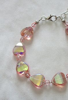 This delicate faceted pink heart bracelet is made with 12mm transparent hearts and 4mm pink Czech crystals. It adjusts along the chain from 7 to 8 inches. The metals are silver plated. This bracelet will be slipped into an organza bag and shipped in a bubble mailer. Pink Heart Bracelet For Parties, Pink Heart-shaped Beaded Bracelets For Party, Adjustable Heart-shaped Crystal Bracelet, Valentine's Day Adjustable Crystal Bracelet, Adjustable Pink Faceted Crystal Bracelet, Adjustable Heart-shaped Pink Crystal Bracelet, Pink Heart Crystal Bracelet With Heart Beads, Adjustable Pink Heart Bracelet For Parties, Adjustable Pink Heart Bracelet For Party