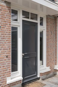 a black front door on a brick building