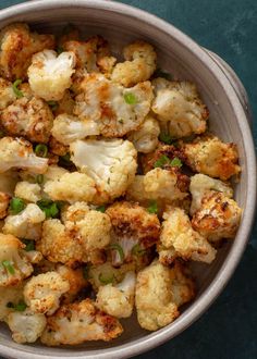 a bowl filled with cauliflower on top of a table