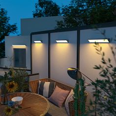 an outdoor patio with sunflowers and lights