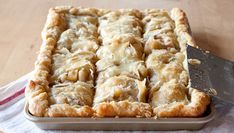 a close up of a pie on a table with a knife