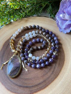 This necklace is 90 beads of Amethyst, Lepidolite, Petrified Fluorite, Citrine, Clear Quartz, and is finished with Brass spacers + a gorgeous flashy purple Labradorite pendant. Created + packed with love + intention! 💫 Mala purchases come with shipping insurance to ensure they arrive safely! 💕 Free US Shipping on $100+ orders. Shipped in 2-5 business days from Florida. 🌞🌴 Every order helps a kitten! 🐱 2023 The Crystalline Moon Dainty Chain Necklace, Knotted Mala, Hand Knotted Necklace, Magic Hands, Crescent Moon Pendant, Practical Magic, Orders Shipped, Purple Labradorite, Knot Necklace