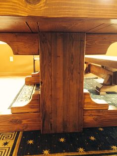 a wooden table sitting on top of a rug