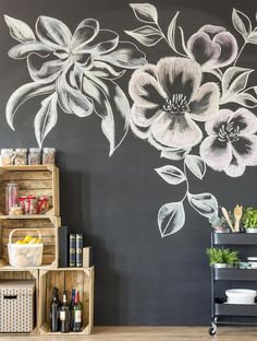 a black and white wall with flowers painted on it