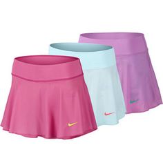 two women's tennis skirts, one in pink and the other in light blue