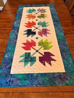 a quilted table runner with colorful arrows on it