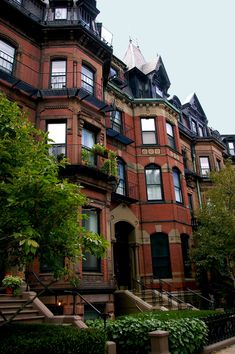 an apartment building with many windows and balconies