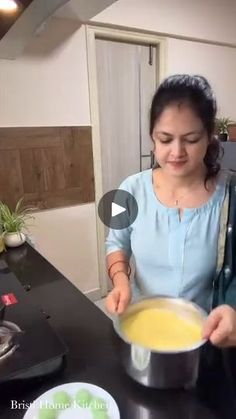 a woman is mixing some food in a bowl