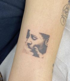 a woman's arm with a tattoo on it that has an image of a woman