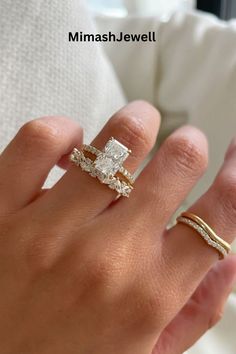 a woman's hand with two rings on it