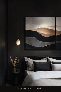 a bedroom with black walls and white bedding, two paintings above the headboard