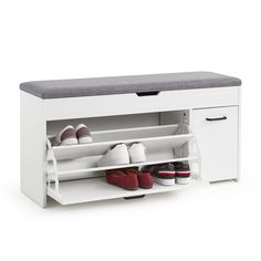 a white shoe rack with shoes on it and a gray cushion over the top for storage