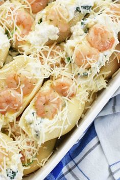 a casserole dish with shrimp, spinach and fettuccine in it