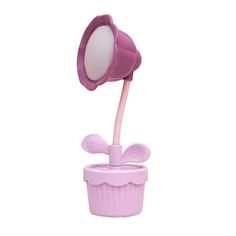 a pink lamp that is on top of a cup