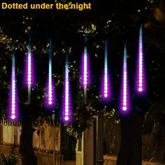 several purple lights are lit up in the dark