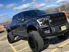 a large black truck parked in a parking lot