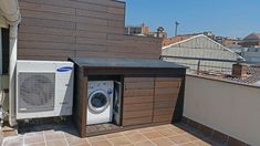 an air conditioner sitting on top of a roof next to a dryer box