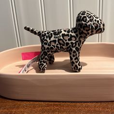 a toy dog is sitting in a bowl