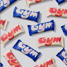 several gummy bars are arranged on a white surface with red and blue wrappers