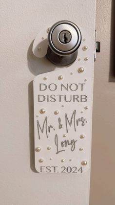 a door handle with a sign on it that says don't disturb mr and mrs long