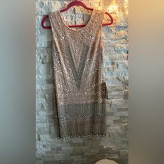 Looks Luxurious And Classy Perfect For Holidays Luxury Sleeveless Sequin Dress For Holiday Party, Beaded Sleeveless Dress For Festive Occasions, Beaded Sleeveless Festive Dress, Sleeveless Beaded Festive Dress, Embellished Beige Dresses For Festive Occasions, Glamorous Beige Embellished Dresses, Beige Embellished Party Dress, Glamorous Beige Mini Dress With Sequins, Glamorous Beige Sequin Dress