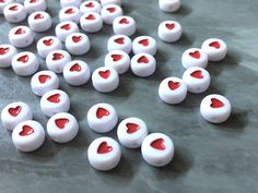 small white and red heart shaped candies on a table