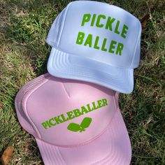 Top off your gameday look with the Pickleballer Paddles Trucker Hat! This light pink cap is perfect for the competitive but cute pickleball fan. Show off your hat and gain some cheers from the sidelines. Get your game on! Light pink trucker hat with green PUFFED Ink. Adjustable Novelty Sports Hats, Pink Hat For Sports Events, One Size, Pink Hat For Sports Events, One Size Fits Most, Pink Sports Event Hat, Pink Hats For Spring Sports Events, Spring Adjustable Trucker Hat For Sports Events, Pink Trucker Hat For Baseball Season, Pink Trucker Hat For Sports, One Size, Pink Trucker Hat For Sports, One Size Fits Most