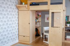 there is a bunk bed with a desk underneath it