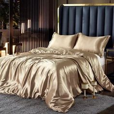 a bed with gold sheets and pillows in a room