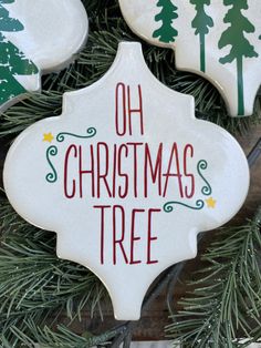 christmas ornaments are hanging from the branches of a tree with words on them that read, oh christmas tree