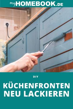 a person is holding scissors in front of a blue cabinet with the words homebook de diy kuchenfroniten neu lackieren