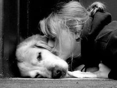 a girl and her dog are cuddling in front of an open door with their head on the floor