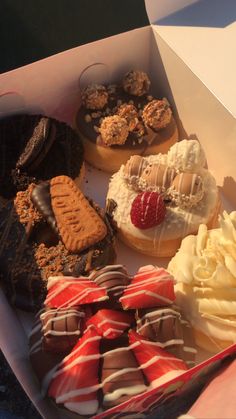 a box filled with lots of different types of donuts