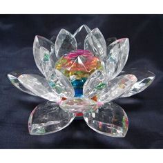 a clear glass flower with multicolored crystals on it's petals and leaves