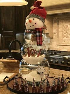 a snowman made out of glass sitting on top of a counter