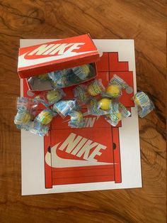 a box of nike candy on top of a wooden table