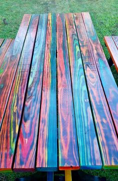 two wooden benches sitting on top of a grass covered field