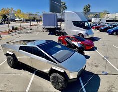 an electric vehicle is parked in a parking lot with other vehicles around it and on the ground