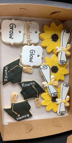 decorated cookies in a box with graduation caps and sunflowers