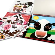 several children's notebooks with pictures of farm animals on them, including a cow