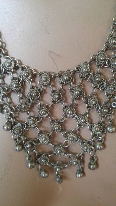 "80s chain maille and bells Indian hippie boho bib necklace. Comprises of silvertone chain hoops and little Indian bells at the ends. Hook and loop fastener at the end. Length 12 1/4\", width across widest part 3 3/4\"" Festival Silver Beaded Bib Necklaces, Festival Silver Beaded Bib Necklace, Bohemian Chainmail Metal Jewelry, Silver Bohemian Bib Necklace Choker, Festival Metal Bells Jewelry, Vintage Silver Bib Necklace, Handmade Silver Bib Necklace For Festivals, Gold Dragon, Chain Maille