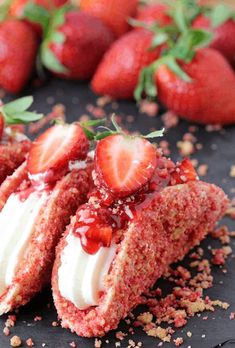 strawberry shortcakes with whipped cream and sprinkles on a black plate