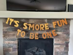 a fire place with a sign that says it's smore fun to be one