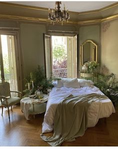 a large bed sitting in the middle of a bedroom next to two tables and chairs