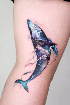 a woman's thigh with a tattoo of a humpback whale on it