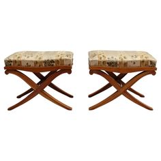 a pair of stools that are sitting next to each other on a white background