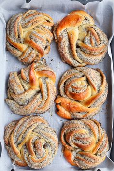 several different types of breads on a baking sheet with powdered sugar sprinkled on top