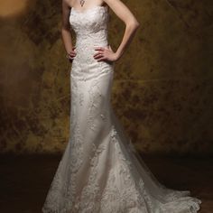 a woman in a white wedding dress posing for a photo with her hands on her hips