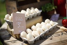 an egg carton filled with marshmallows on top of a wooden table